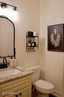 691 Apona St, Diamondhead, MS 39525 - half bathroom featuring vanity, toilet, and baseboards