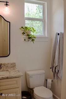 691 Apona St, Diamondhead, MS 39525 - bathroom featuring toilet, vanity, and baseboards