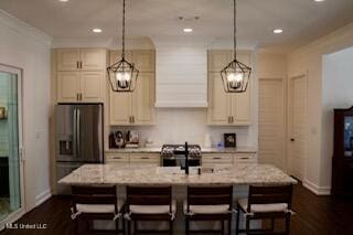 691 Apona St, Diamondhead, MS 39525 - kitchen with appliances with stainless steel finishes, a chandelier, a kitchen bar, and recessed lighting