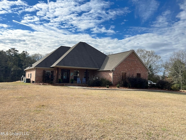 view of front of property featuring a front yard and central air condition unit