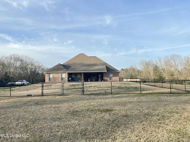 view of front facade featuring fence private yard, brick siding, and a front lawn