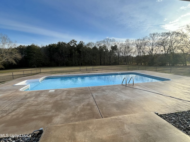 view of swimming pool with a patio area, fence, and a fenced in pool