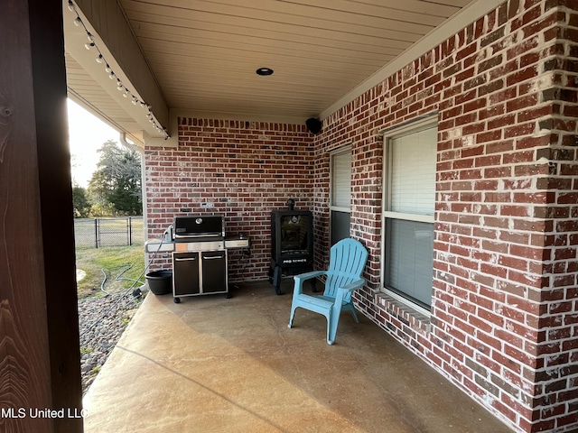 view of patio with a grill and fence