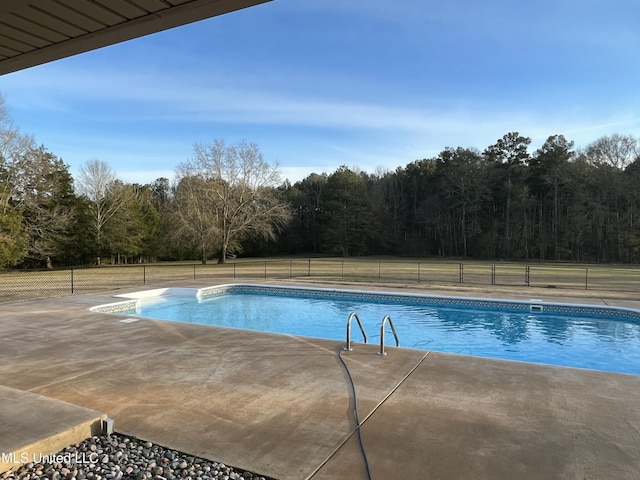 view of swimming pool featuring fence, a fenced in pool, and a patio