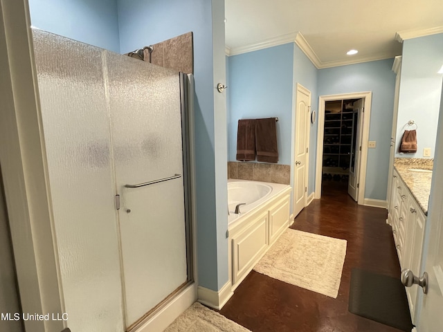 full bath with vanity, baseboards, ornamental molding, a shower stall, and a bath