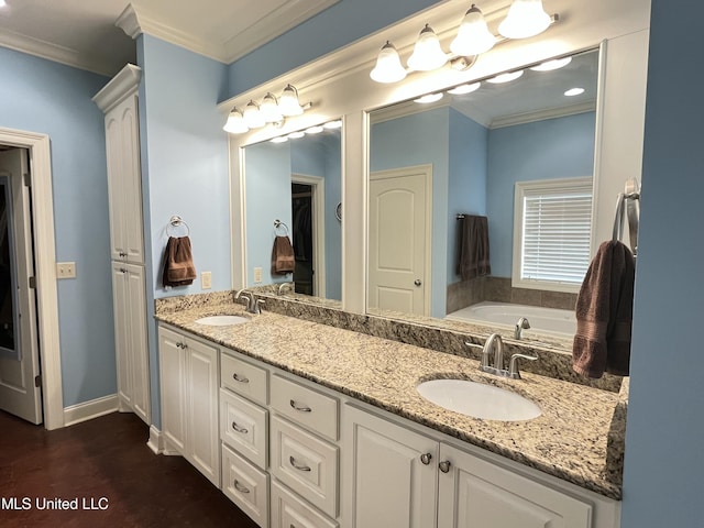 bathroom with ornamental molding, a closet, a sink, and double vanity