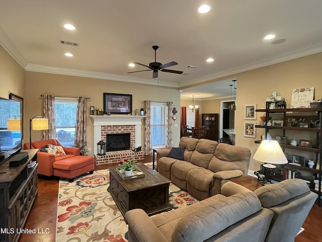 living area with recessed lighting, visible vents, ornamental molding, a fireplace, and ceiling fan with notable chandelier