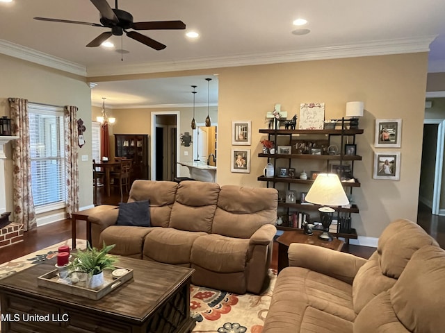 living room with recessed lighting, ceiling fan with notable chandelier, wood finished floors, baseboards, and crown molding