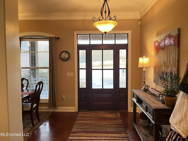 entrance foyer featuring dark wood-style floors, baseboards, and crown molding