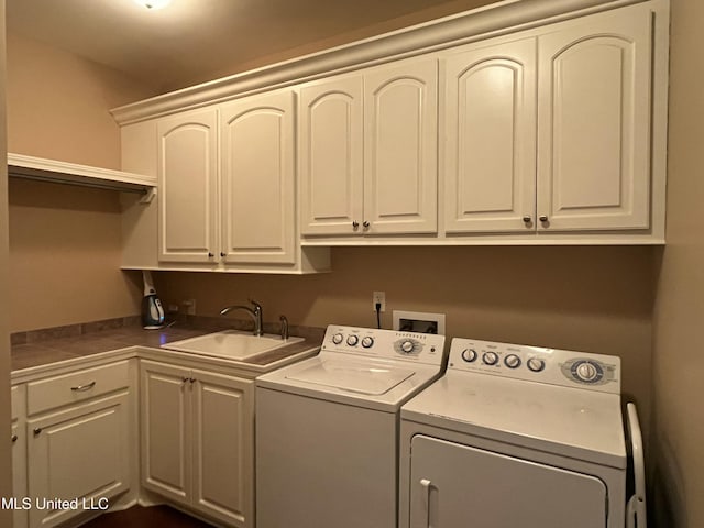 laundry room with cabinet space, a sink, and separate washer and dryer