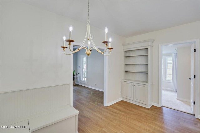 322 NW 2nd Ave, Magee, MS 39111 - unfurnished dining area featuring a chandelier and light wood-type flooring