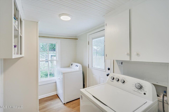 322 NW 2nd Ave, Magee, MS 39111 - laundry area featuring cabinet space, light wood-style flooring, washer and dryer, and ornamental molding