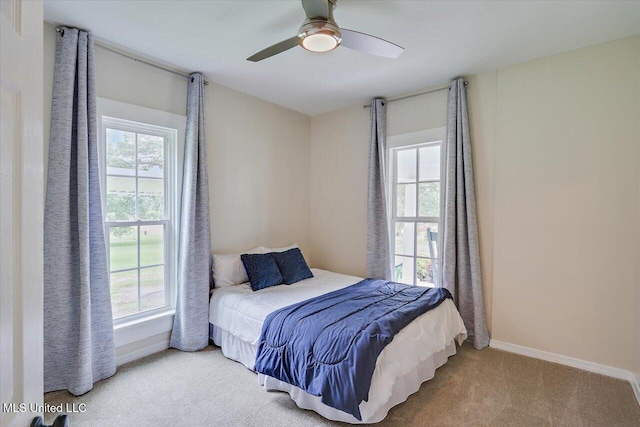 322 NW 2nd Ave, Magee, MS 39111 - carpeted bedroom with multiple windows and ceiling fan