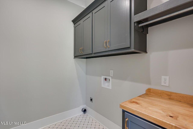 clothes washing area featuring hookup for an electric dryer, washer hookup, and cabinets