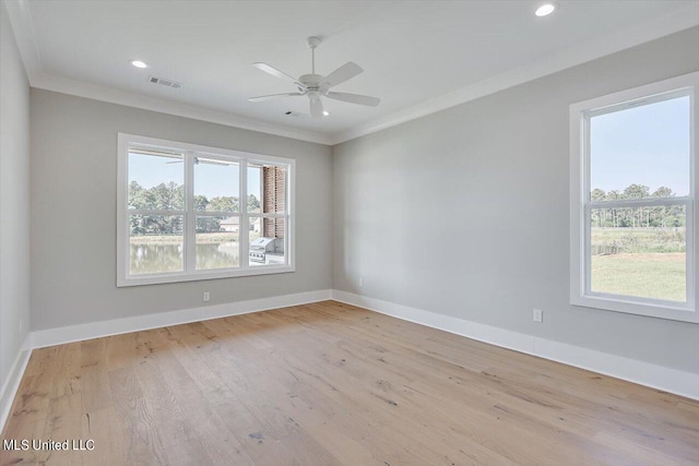 empty room with crown molding, light hardwood / wood-style flooring, a healthy amount of sunlight, and ceiling fan