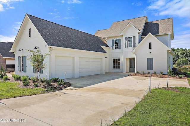 view of front of house with a front yard and a garage