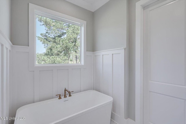 bathroom with a tub and plenty of natural light