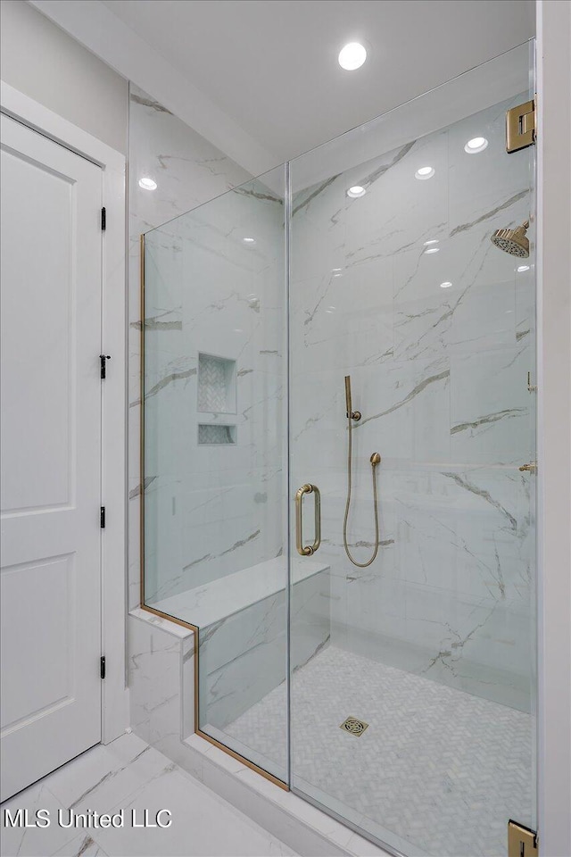 bathroom featuring a shower with shower door