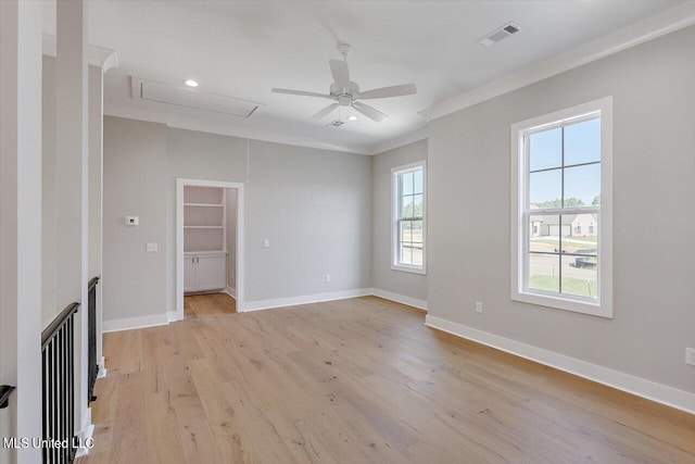 unfurnished living room featuring crown molding, light wood-type flooring, and ceiling fan