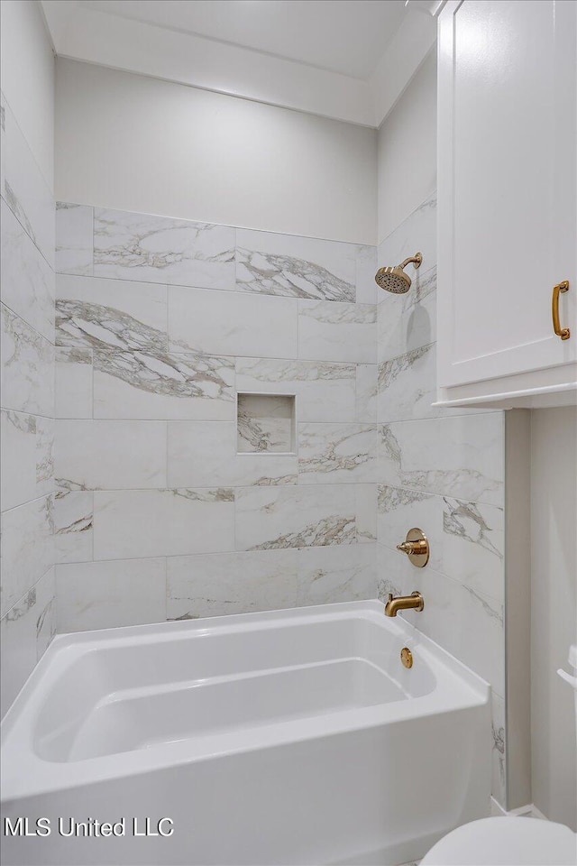 bathroom with toilet and tiled shower / bath combo