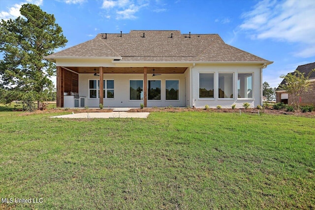 rear view of house with a yard