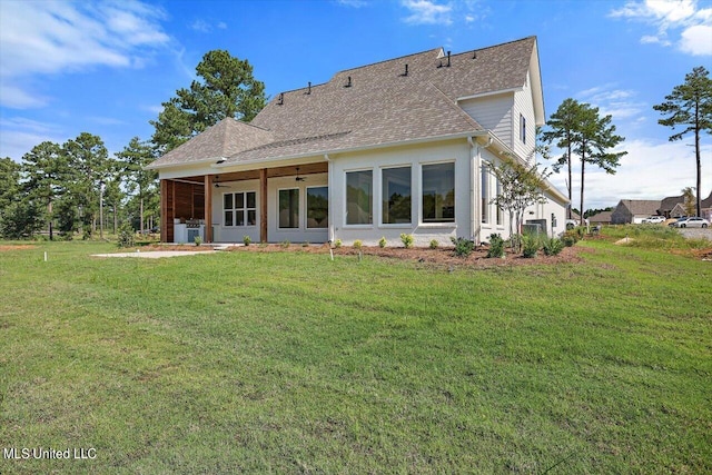 back of property featuring a lawn