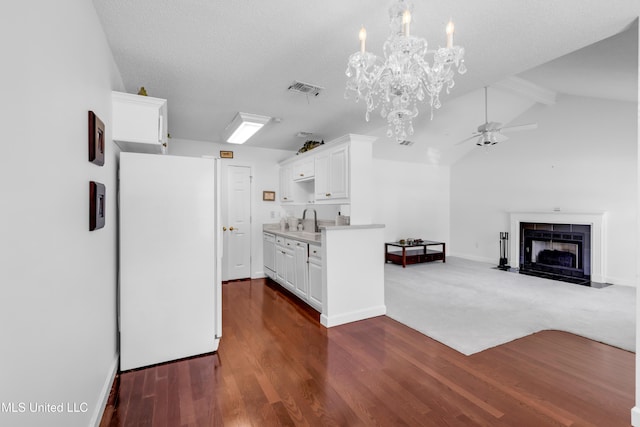 2390 Carter Rd, Biloxi, MS 39531 - kitchen featuring a fireplace with flush hearth, ceiling fan, white cabinetry, light countertops, and a sink