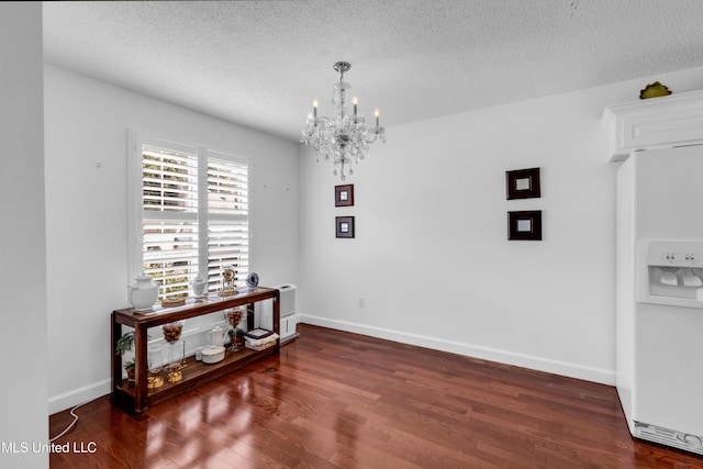 2390 Carter Rd, Biloxi, MS 39531 - dining space featuring a chandelier, a textured ceiling, wood finished floors, and baseboards