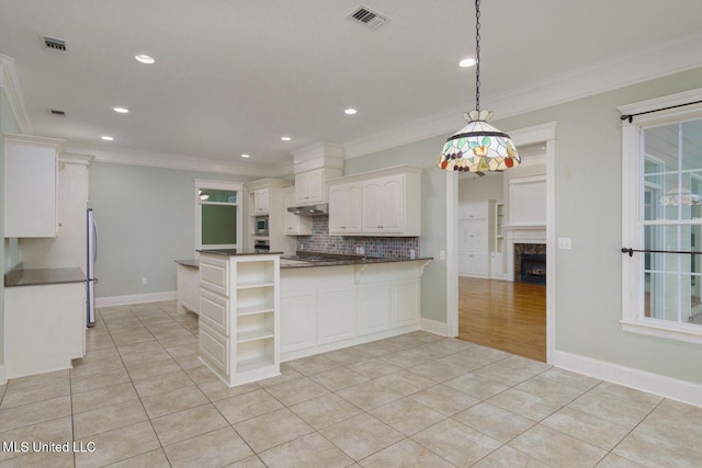 54 Saint Annes Dr, Hattiesburg, MS 39401 - kitchen featuring open shelves, crown molding, dark countertops, light tile patterned floors, and a peninsula