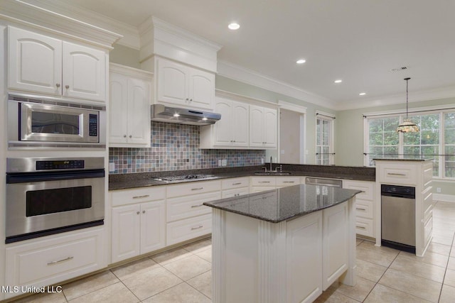 54 Saint Annes Dr, Hattiesburg, MS 39401 - kitchen featuring stainless steel appliances, under cabinet range hood, light tile patterned flooring, dark stone counters, and crown molding