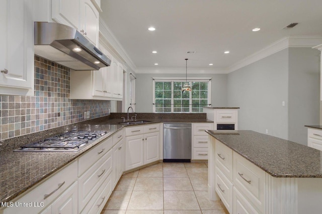 54 Saint Annes Dr, Hattiesburg, MS 39401 - kitchen with appliances with stainless steel finishes, under cabinet range hood, crown molding, decorative backsplash, and light tile patterned flooring
