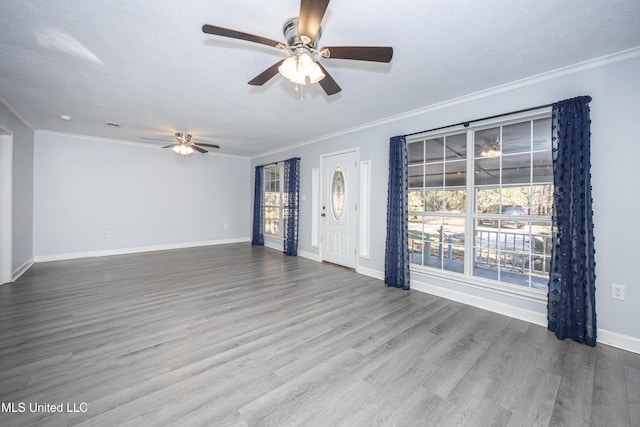 unfurnished living room with a textured ceiling, ceiling fan, ornamental molding, and hardwood / wood-style flooring