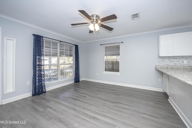 interior space featuring ceiling fan, crown molding, and hardwood / wood-style flooring