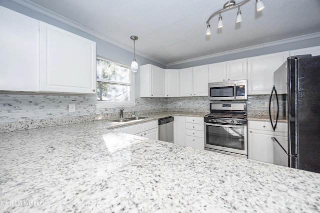 kitchen featuring pendant lighting, sink, light stone countertops, stainless steel appliances, and white cabinets