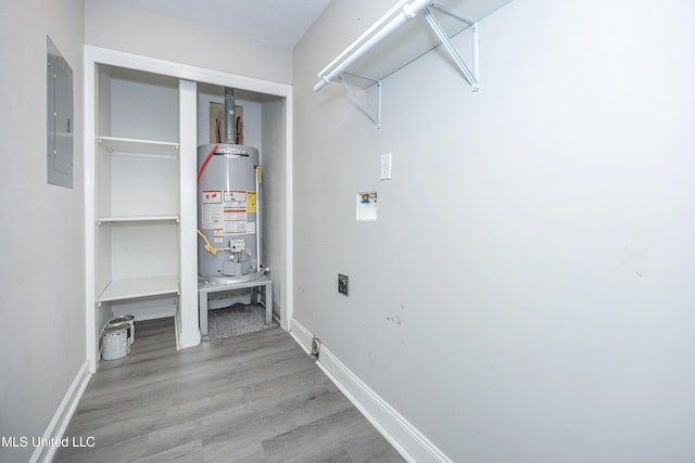 laundry area with electric dryer hookup, hookup for a washing machine, gas water heater, electric panel, and light hardwood / wood-style flooring