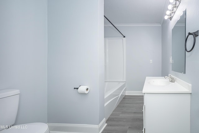 full bathroom featuring toilet, hardwood / wood-style flooring, shower / bathing tub combination, ornamental molding, and vanity