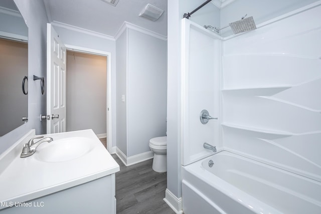 full bathroom featuring washtub / shower combination, toilet, ornamental molding, and vanity