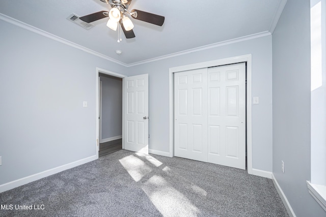 unfurnished bedroom featuring ceiling fan, a closet, carpet floors, and ornamental molding