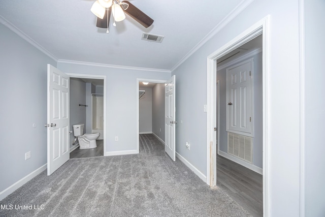 unfurnished bedroom with ensuite bath, a closet, ornamental molding, carpet flooring, and ceiling fan