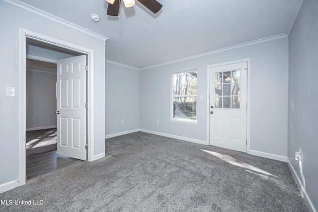 carpeted spare room with ceiling fan and crown molding