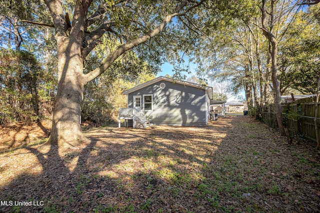 rear view of property featuring a wooden deck