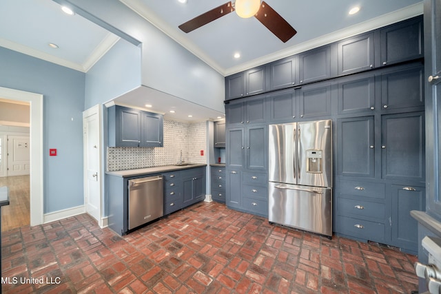 905 Franklin St, Corinth, MS 38834 - kitchen featuring appliances with stainless steel finishes, ornamental molding, ceiling fan, a sink, and brick floors