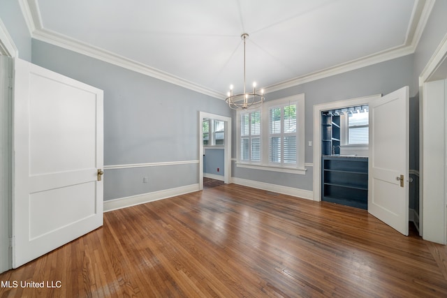 905 Franklin St, Corinth, MS 38834 - spare room with a chandelier, ornamental molding, wood finished floors, and baseboards