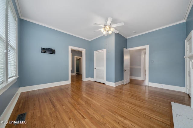 905 Franklin St, Corinth, MS 38834 - spare room featuring a ceiling fan, plenty of natural light, crown molding, and light wood-style floors