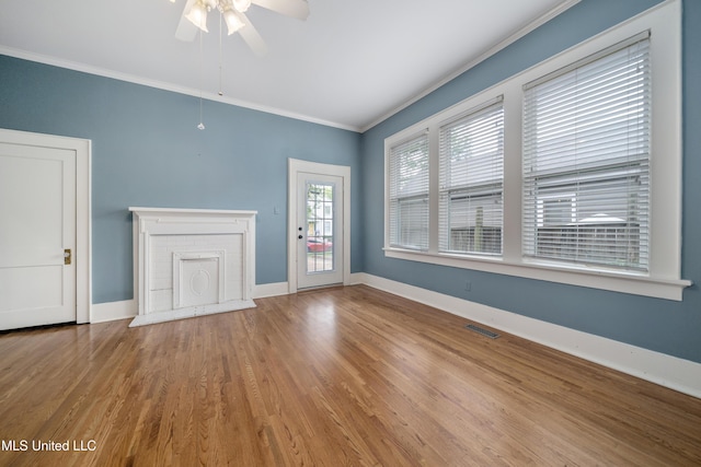 905 Franklin St, Corinth, MS 38834 - unfurnished living room featuring ornamental molding, ceiling fan, wood finished floors, and baseboards