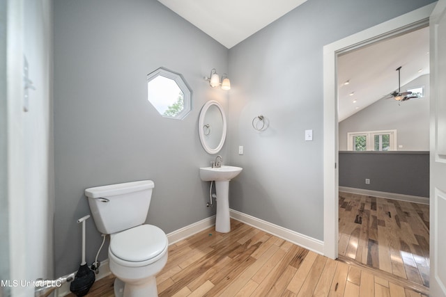 905 Franklin St, Corinth, MS 38834 - bathroom featuring vaulted ceiling, hardwood / wood-style floors, ceiling fan, toilet, and healthy amount of natural light