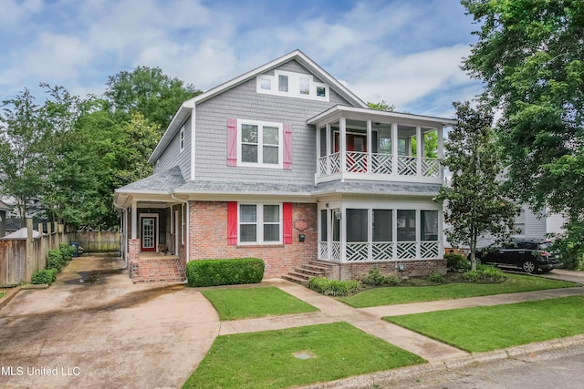 905 Franklin St, Corinth, MS 38834 - view of front of house with brick siding, a balcony, roof with shingles, and concrete driveway