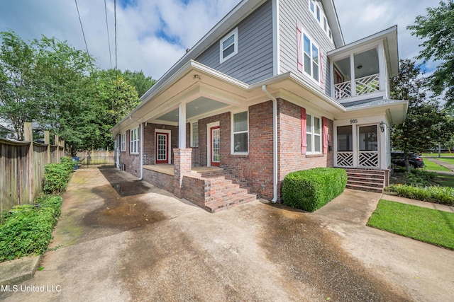 905 Franklin St, Corinth, MS 38834 - view of front of property featuring a porch, brick siding, a balcony, and driveway