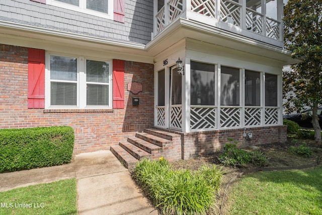 905 Franklin St, Corinth, MS 38834 - view of exterior entry featuring a balcony and brick siding