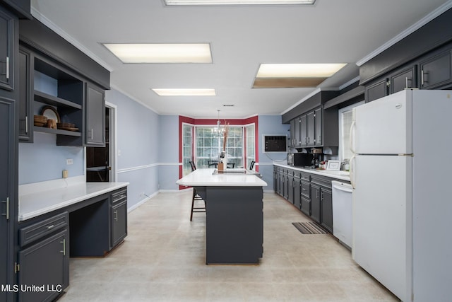 kitchen with white appliances, light countertops, and ornamental molding